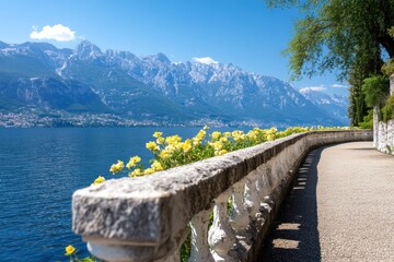 A scenic waterfront view featuring a flower-lined pathway, stunning mountains, and clear blue skies.