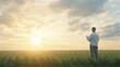 © Kanisorn - A modern farmer using a tablet in a smart farm, lush fields, sunlight streaming through clouds