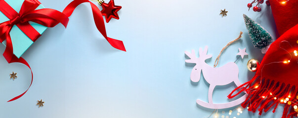 Wall Mural - christmas blue light background with xmas sparkling lights garland and christmas tree decoration, to