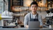 © sungedi - Barista Using Laptop at Coffee Shop Counter