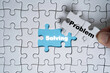 © Dilok - Hand move out problem wording on jigsaw and found solving wording for solution concept.