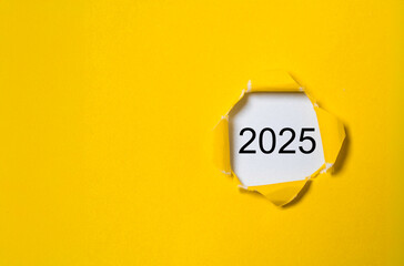 Wall Mural - 2025 inside yellow punch paper with copy space for preparation of merry christmas and happy new year