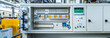 © imran - Well-organized electrical control box in a factory setting -