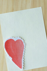 Poster - heart with fancy edge on blank paper and wood