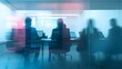 © sungedi - Blurred Silhouettes of People Working on Laptops in an Office
