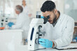 © peopleimages.com - Man, scientist and microscope for research in lab with disease experiment, medical study and dna process. Researcher, biotechnology and molecule exam with engineering, vaccine and healthcare solution