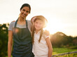 © FotoPush/peopleimages.com - Farm, portrait and woman with child, environment and gardening with mom, outdoor and smile for growth. Agriculture, embrace and helping for farming, sustainability and parent with kid and lens flare