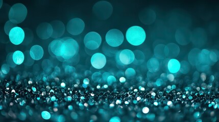 Abstract teal and blue bokeh background with glitter.