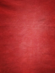 Wall Mural - Red suede background with light in the center. Vertical red texture macro.