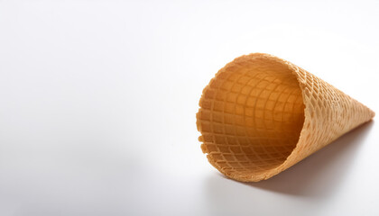 Empty waffle cone ready for ice cream on side position provides copy space for text. background concept isolated white