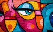 © Valentyna - Vibrant street graffiti featuring abstract faces in a colorful urban setting during daytime