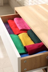 Canvas Print - Chest of drawers with different folded clothes, closeup