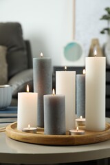 Canvas Print - Beautiful burning candles on light table in room