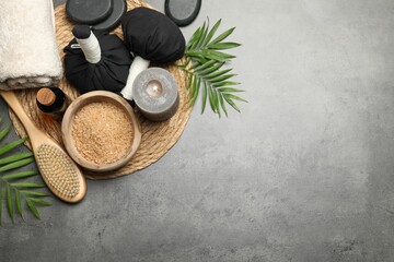 Canvas Print - Spa composition with herbal bags and burning candle on grey table, flat lay. Space for text