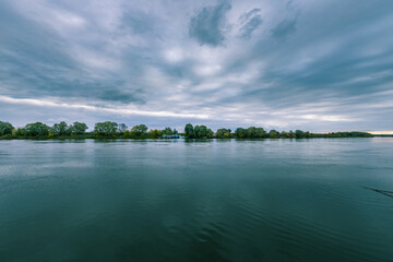 Wall Mural - a calm lake with a cloudy sky in the background