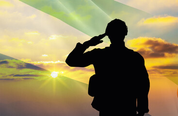 silhouette of a soldier with a background of the sierra leone flag and a sunset or sunrise. concept 