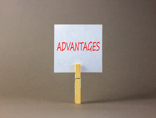 Advantages symbol. Concept word Advantages on beautiful white paper on clothespin. Beautiful grey background. Business advantages concept. Copy space.