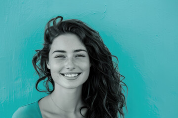 Joyful Young Woman Smiling Brightly Against Vibrant Cyan Background