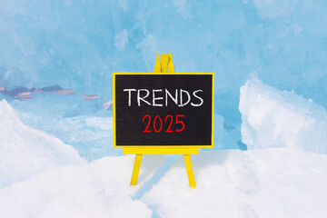 Planning trends 2025 new year symbol. Concept words Trends 2025 on beautiful yellow chalk blackboard. Beautiful Baikal lake blue ice background. Business trends 2025 new year concept. Copy space.