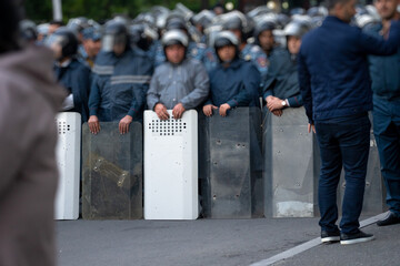 Sticker - Police with shields during a protest in the city, political unrest