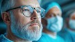 © Anna - A surgeon, wearing glasses and a surgical gown, concentrates intently while another medical professional assists in a high-stakes surgical operation