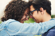 © CamPen2000/peopleimages.com - Happy couple, love and forehead touch outdoor with hug, support and trust with loyalty. Man, woman and embrace in park with glasses, commitment and excited for reunion with relationship development
