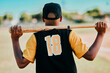 © HockleyM4/peopleimages.com - Baseball, player and person with bat, back and fitness with practice, outdoor and preparing for game. Sports, training and wellness of athlete, field and workout for performance, active and match
