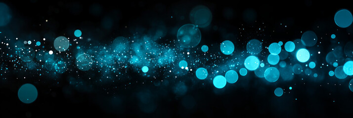 Abstract blue and white bokeh lights on a black background.