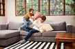 © HockleyM4/peopleimages.com - Happy dad, son and sofa with pillow fight for bonding, playing or holiday together at home. Father and playful child, kid or little boy with smile for morning, cushion or fluffy game in living room
