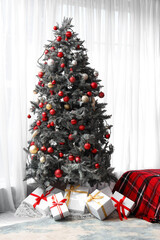 Wall Mural - Interior of festive bedroom with cozy bed, Christmas tree, gift boxes and plaid blanket