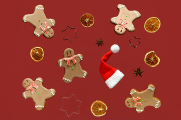 Wall Mural - Sweet gingerbread cookies with Christmas decor on red background.