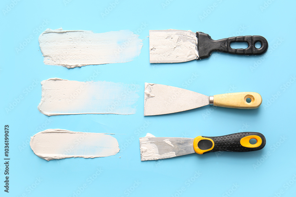 Knives with white putty on blue background