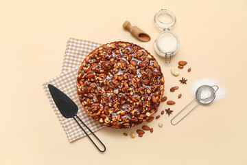 Wall Mural - sweet tart with different nuts and ingredients on beige background