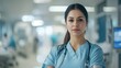 © AYB - A confident healthcare professional in scrubs stands in a hospital setting.