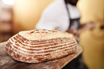 Bread, closeup and wood board for baker, small business owner and pastry kitchen workshop. Chef, confidence and catering for coffee shop, retail and cafe startup for restaurant industry store