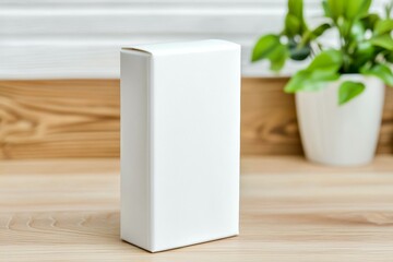 Poster - A white box sits on a wooden table next to a potted plant