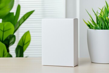 Poster - A white box sits on a wooden table next to a potted plant