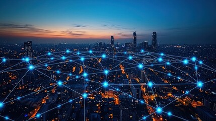 nighttime aerial view of a city with a network of glowing blue lines connecting buildings