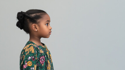 African little girl wearing moroccan kaftan isolated on gray