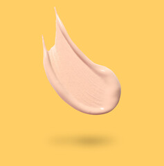 Sticker - Skin foundation in air on golden background. Cosmetic product