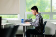 © fotolite - A student studying and doing work in a classroom