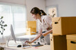© PaeGAG - Happy asian sme business owner is using her computer to check sales of her online store and prepare orders for shipping