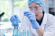 © Supapich - Woman research scientist biology chemistry medicine pouring liquid from beaker to test tube indoor science laboratory room, adult female person blue glove work discovery experiment medical chemist