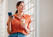 © KayExam/peopleimages.com - Office, coffee and businesswoman with smartphone for thinking, message and online on social media. Connectivity, female person and creative agency manager with mobile app for joke, beverage and laugh