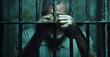 © ClicksdeMexico - A man is behind bars with his hands on the bars