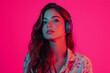 © Em Neems Photography - Realistic photo of a young woman wearing headphones and listening to music against a pink background