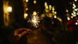© Jhati - Celebrating New Year's Eve with sparklers and festive lights in a joyful gathering
