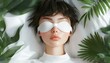 © Wimon - A relaxing moment of self-care as a woman naps with a cozy eye mask in a serene bedroom.