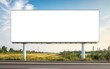 © chusnul - A blank billboard in a rural setting, ready for advertising.