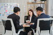 © Wicitr - Business Meeting: A focused and professional business meeting in a modern office setting. The team is engaged in a lively discussion, analyzing data and strategizing for success.